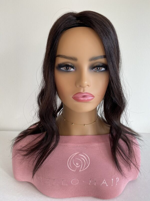 Sienna Silk top hair topper displayed on a mannequin 16 inches in natural black styled in a wave.