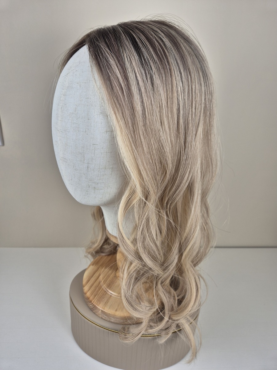Juliet Lace Topper 20 inches in length light neutral blonde ash dimension with a deeper diffused root. displayed on a mannequin