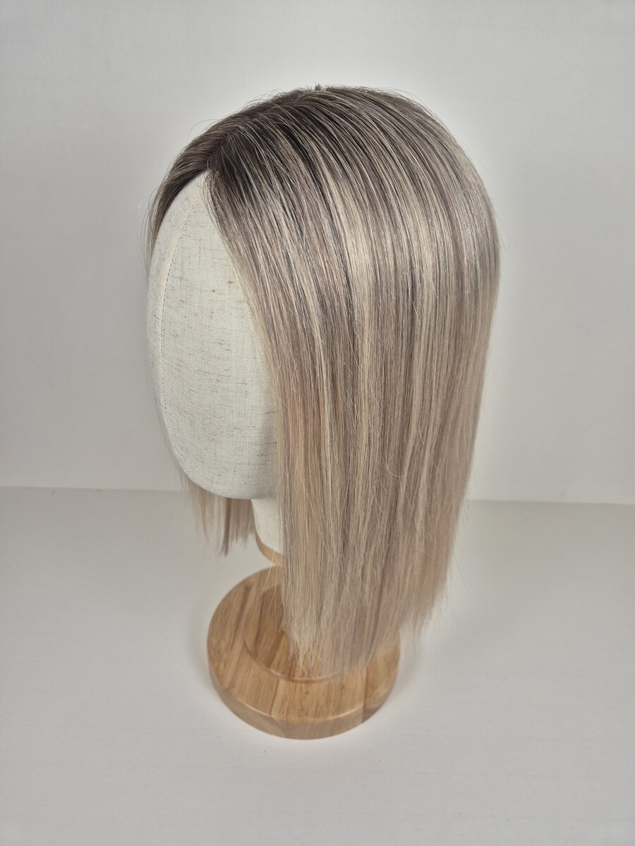 Stephanie Lace Topper 14 inch light neutral blonde ash dimension and root. Displayed on a mannequin