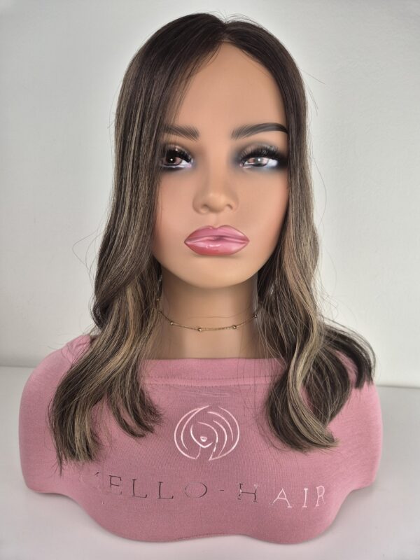 Anna lace top hair topper 16 inches in length dark brown with ash blonde highlights. Displayed on a mannequin