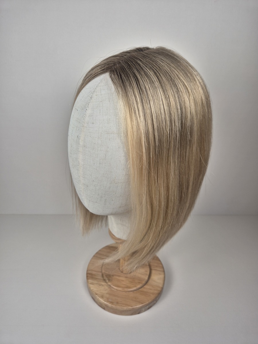 Kelly Lace Topper 14 inch light neutral cool blonde with a subtle deeper root styled straight displayed on a mannequin