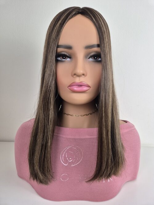 Mia Silk top hair topper 16 inches in length a brunette with golden highlights displayed on a Mannequin