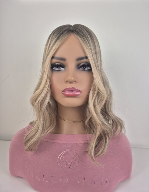 Sian silk top hair topper 16 inches in length blonde with a darker root displayed on a mannequin