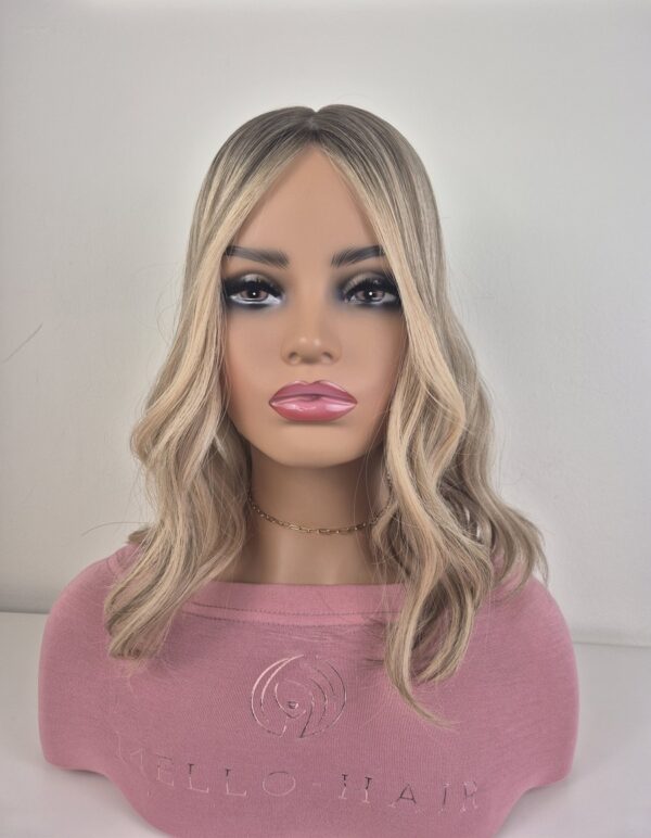 Sian silk top hair topper 16 inches in length blonde with a darker root displayed on a mannequin