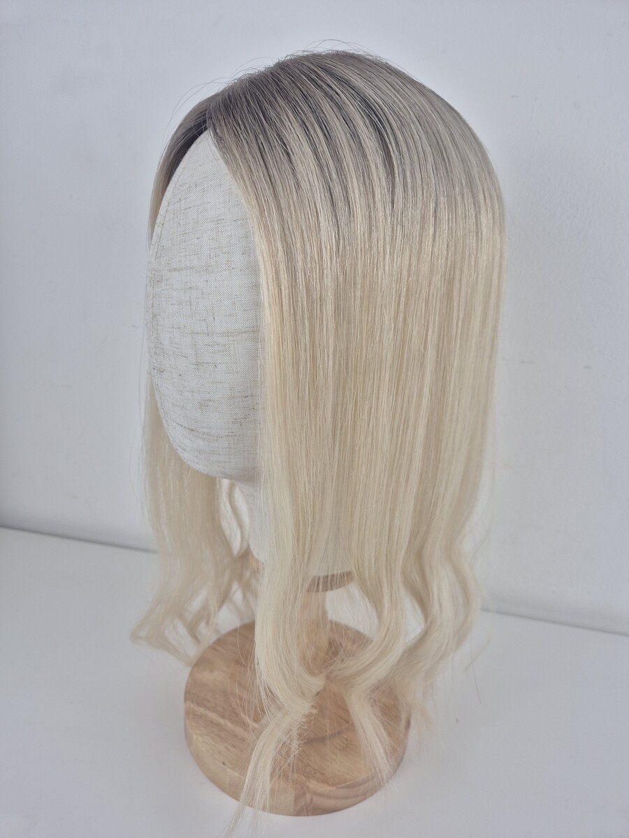 Tiny Topper Aster low density hair topper 16 inches in length cool blonde with a soft ash root displayed on a mannequin