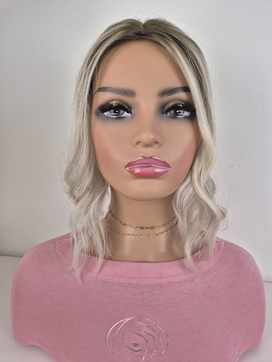 Tiny Topper Aurora 12 inch length ashy blonde with a dark added root displayed on a mannequin