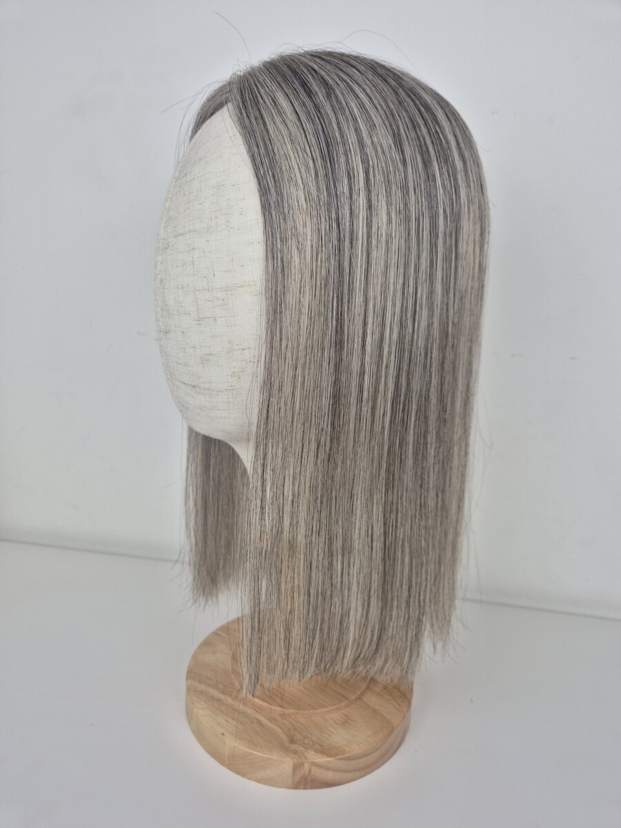 Tiny Topper Evelyn low-density hair topper 16 inch length ash grey blend styled straight displayed on a mannequin