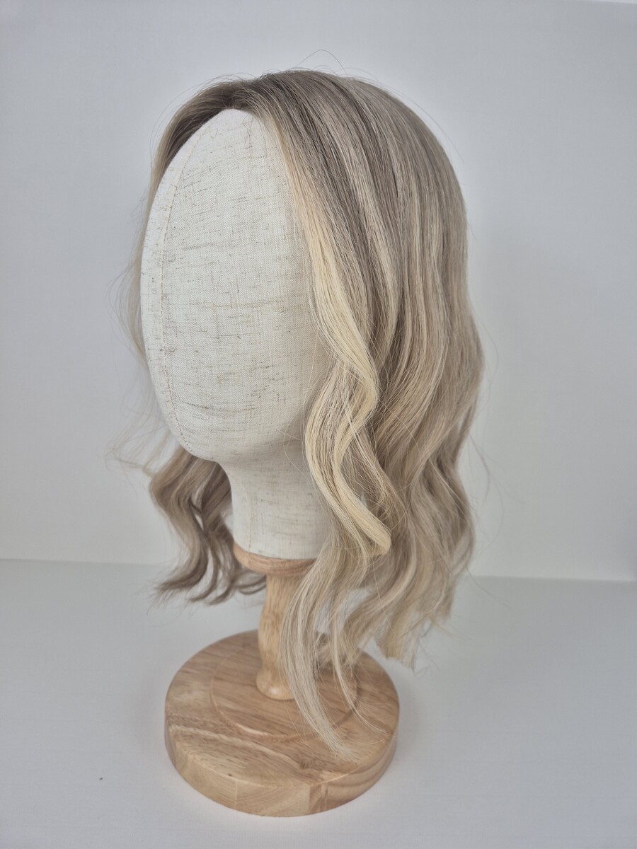 Samantha Lace Topper 16 inches cool toned blonde displayed on a mannequin with soft waves