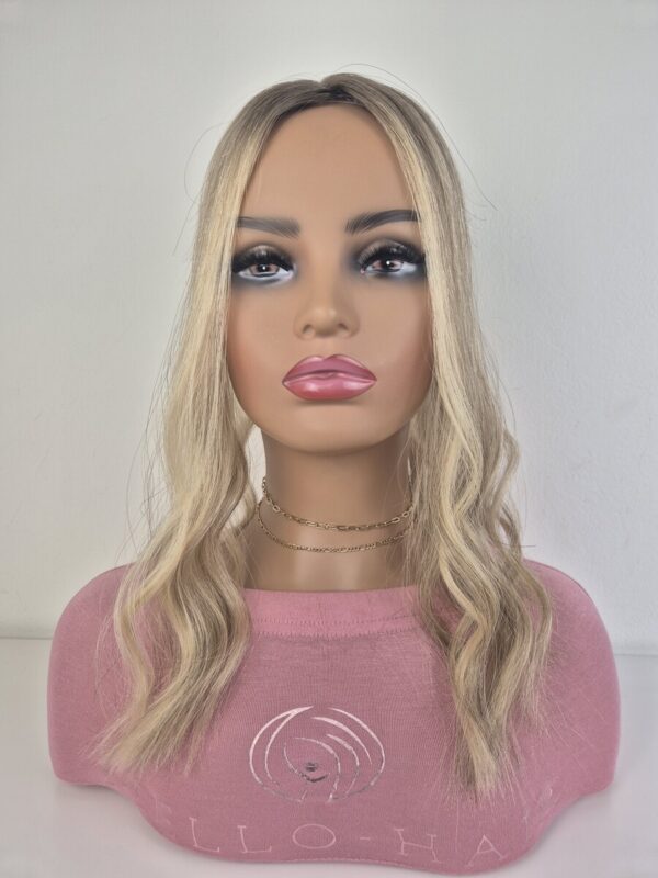 Tiny Topper Belle low-density hair topper 16 inch length neutral to warm blonde with a added root displayed on a mannequin