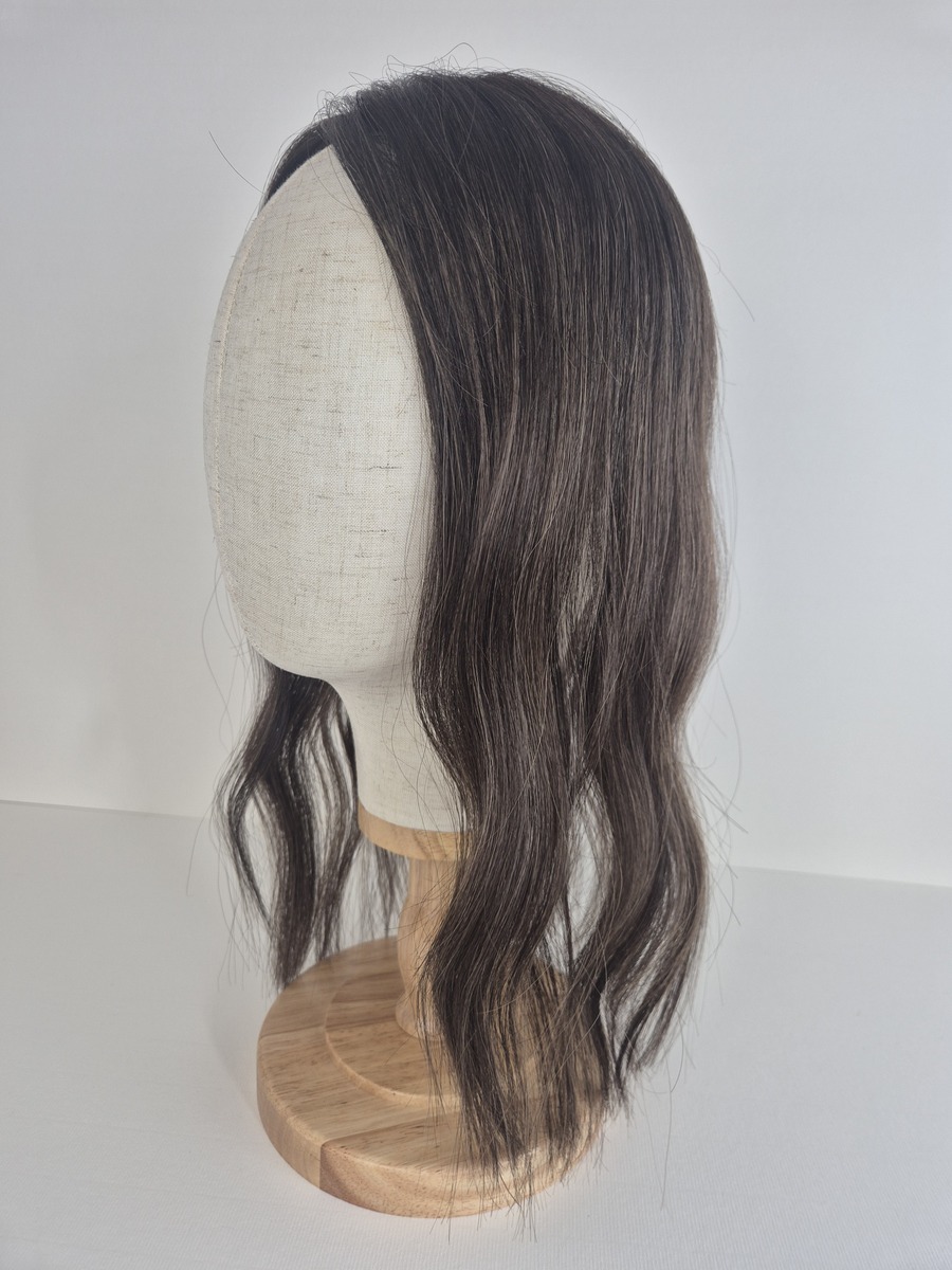 Tiny Topper Amber low-density hair topper 14 inch length dark with fine blonde highlights brown styled with a wave displayed on a mannequin