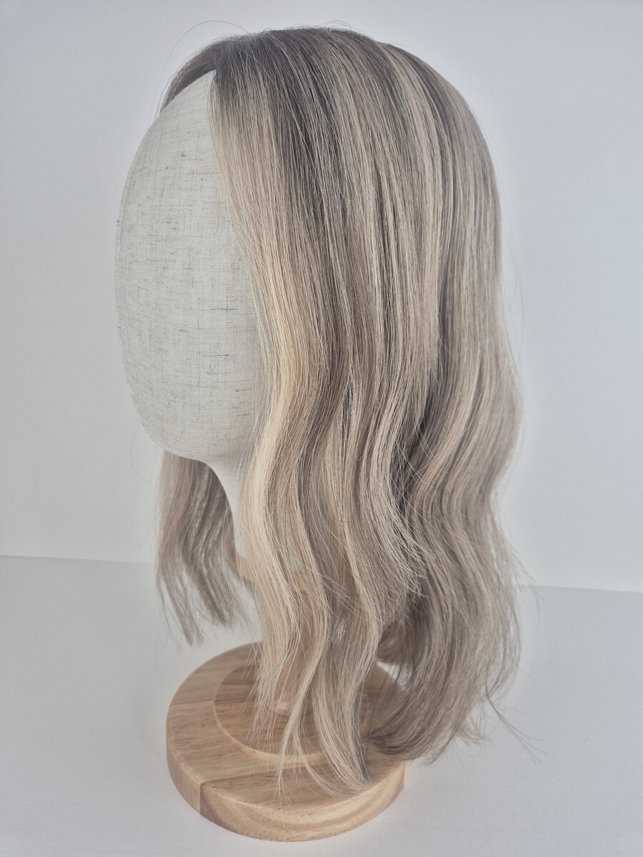 Samantha Lace Topper 16 inches creamy blonde with a dark blonde root and dimensions styled waved displayed on a mannequin