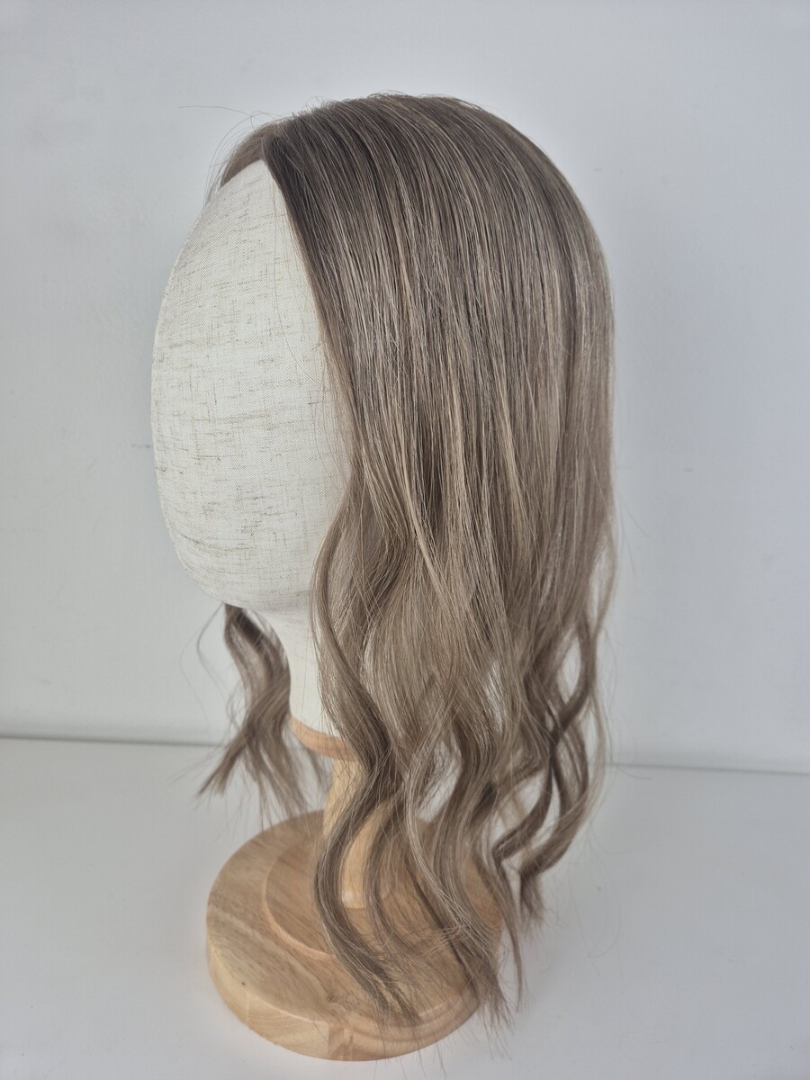 Tiny Topper Colette low-density hair topper 16 inch length cool toned light ash brown styled with a wave displayed on a mannequin