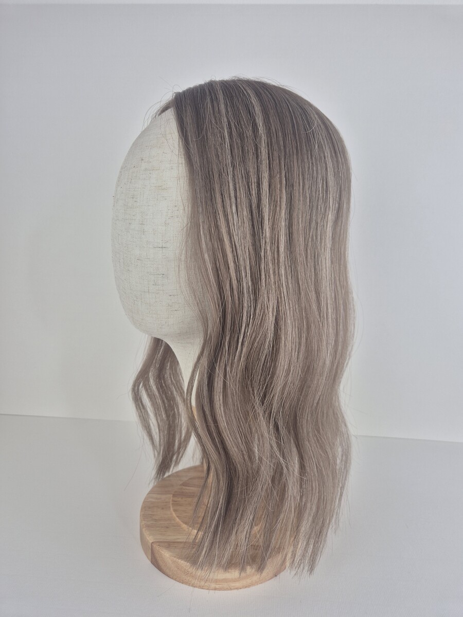 Tiny Topper Colette low-density hair topper 14 inch length light ash brown styled with a wave displayed on a mannequin