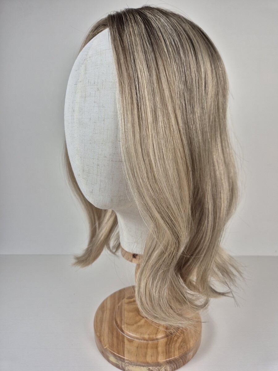 Bianca Ribbon Topper medium beige blonde with ashy dimension and root 16 inch length displayed on a mannequin styled wavy