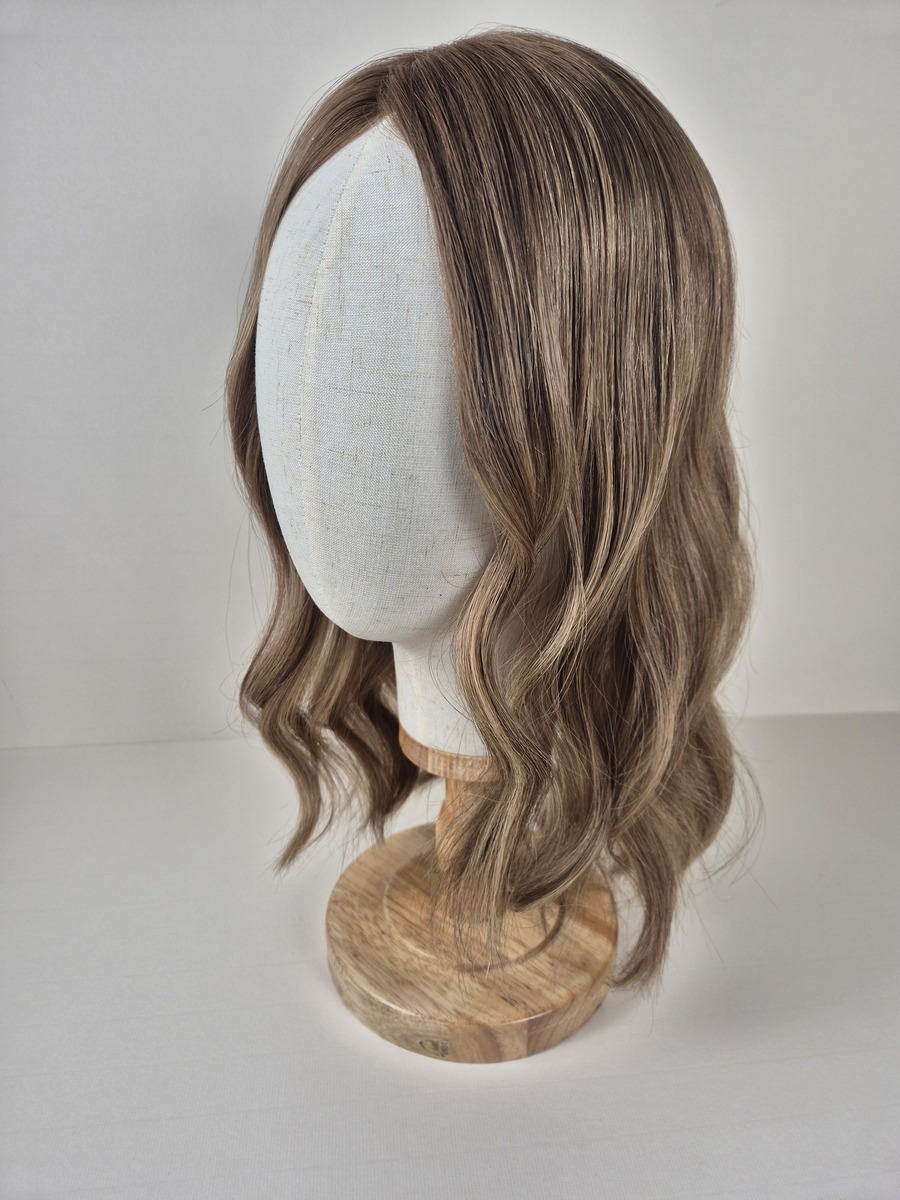 Colette Ribbon Topper cool tones ash brown with beige undertones 16 inch length displayed on a mannequin styled wavy