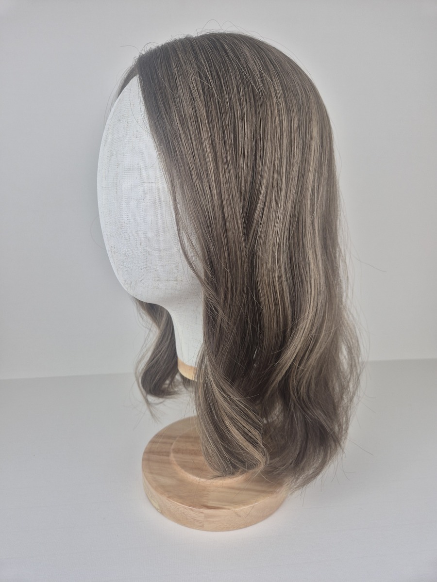 Hayley 8x8 Lace Topper 16 inches light brunette with subtle beige highlights styled waved displayed on a mannequin