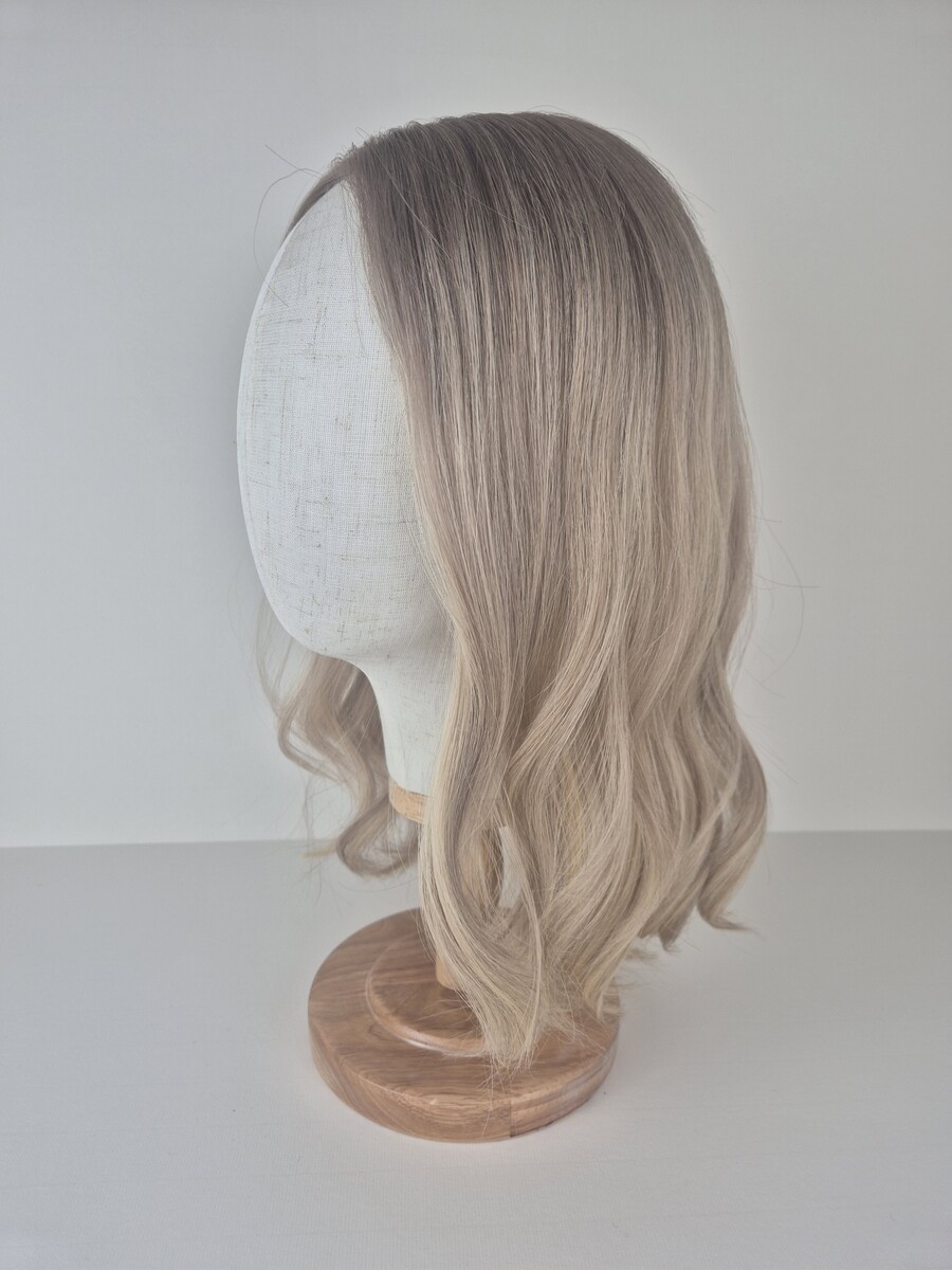Irene 8x8 Lace Topper 16 inches creamy cool blonde with a ash root and dimensions styled waved displayed on a mannequin