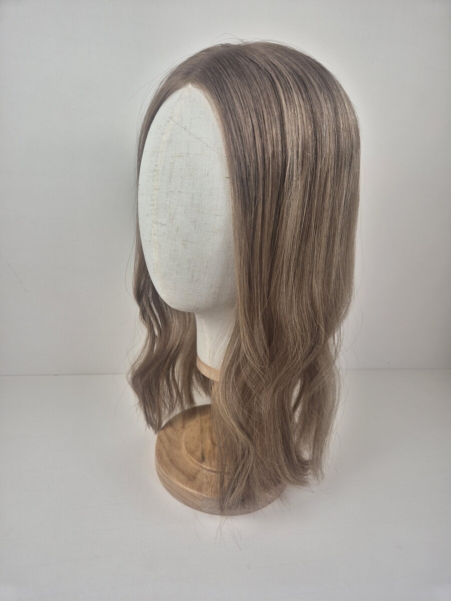 Colette Little Lace topper 16 inches medium blonde with ashy undertones styled wavy displayed on a mannequin