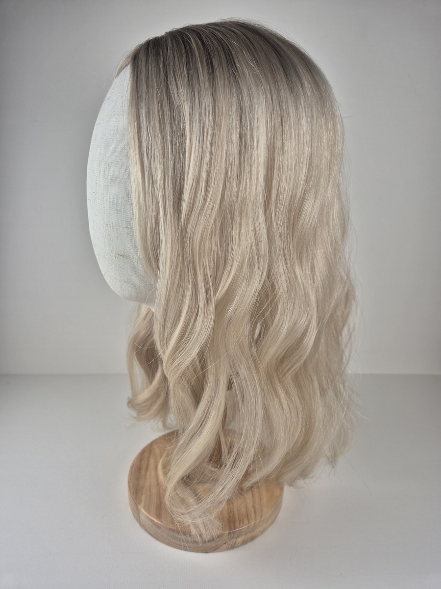Diva lace topper 18 inch length cool-toned beige blonde with soft ashy undertones. Styled with a wave displayed on a mannequin