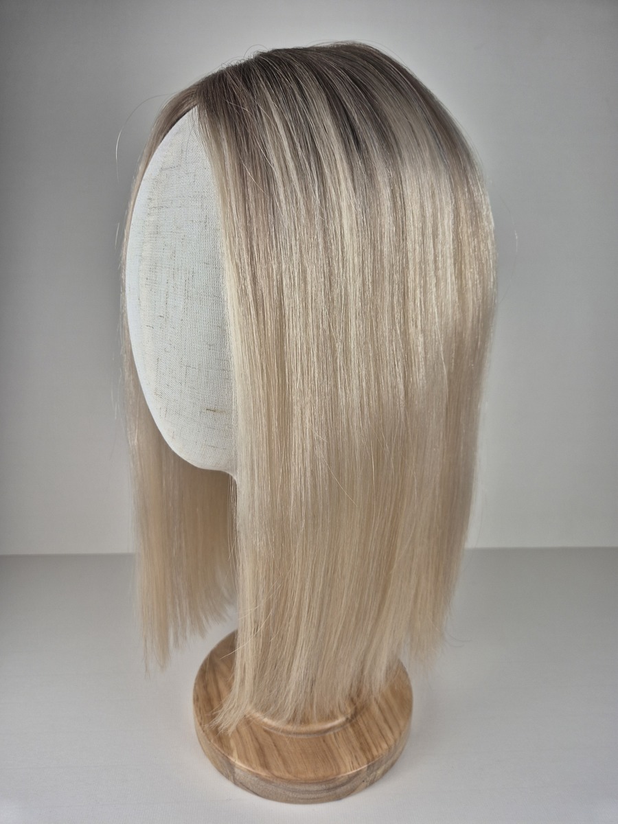Diva Ribbon Silk l topper 16 inches in length cool light blonde with a subtle root shadow styled straight displayed on a Mannequin