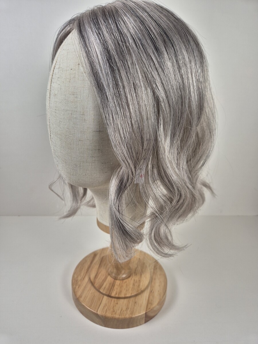 Jasmine 14 inch Ribbon silk topper salt and pepper grey styled with a curl displaced on a mannequin head