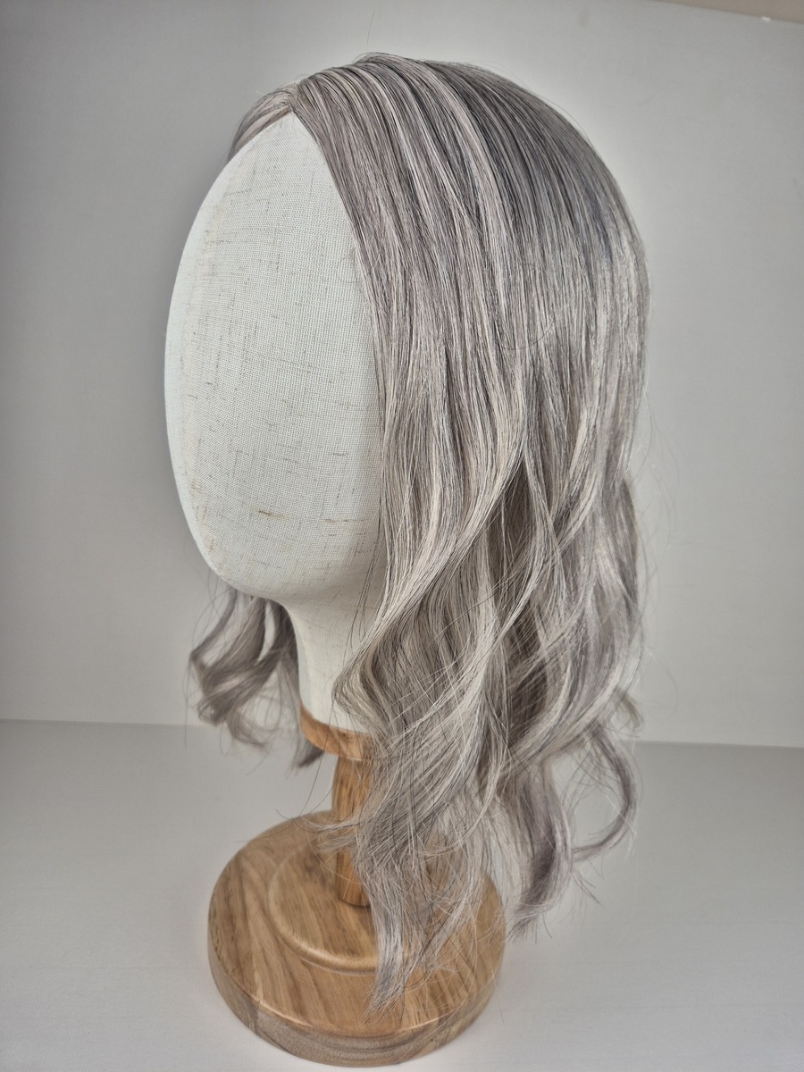 Jasmine Ribbon Silk Silver Grey with Soft Pearl Tones & Natural Salt and Pepper Blend 16 inch styled with a wave and displayed on a mannequin head.