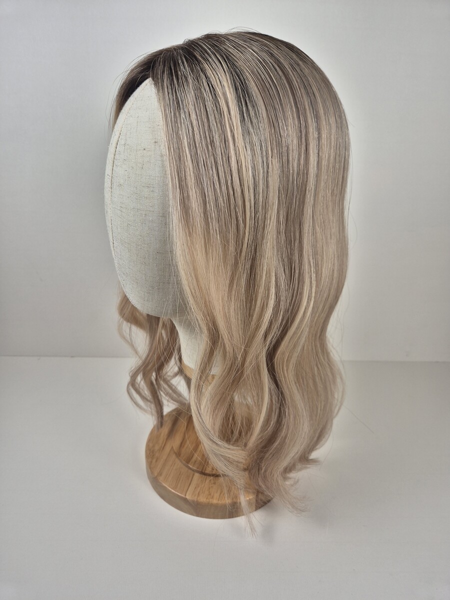 Stephanie 7x7 16 inch Lace topper medium blonde with a root smudge and dimension displayed n a mannequin